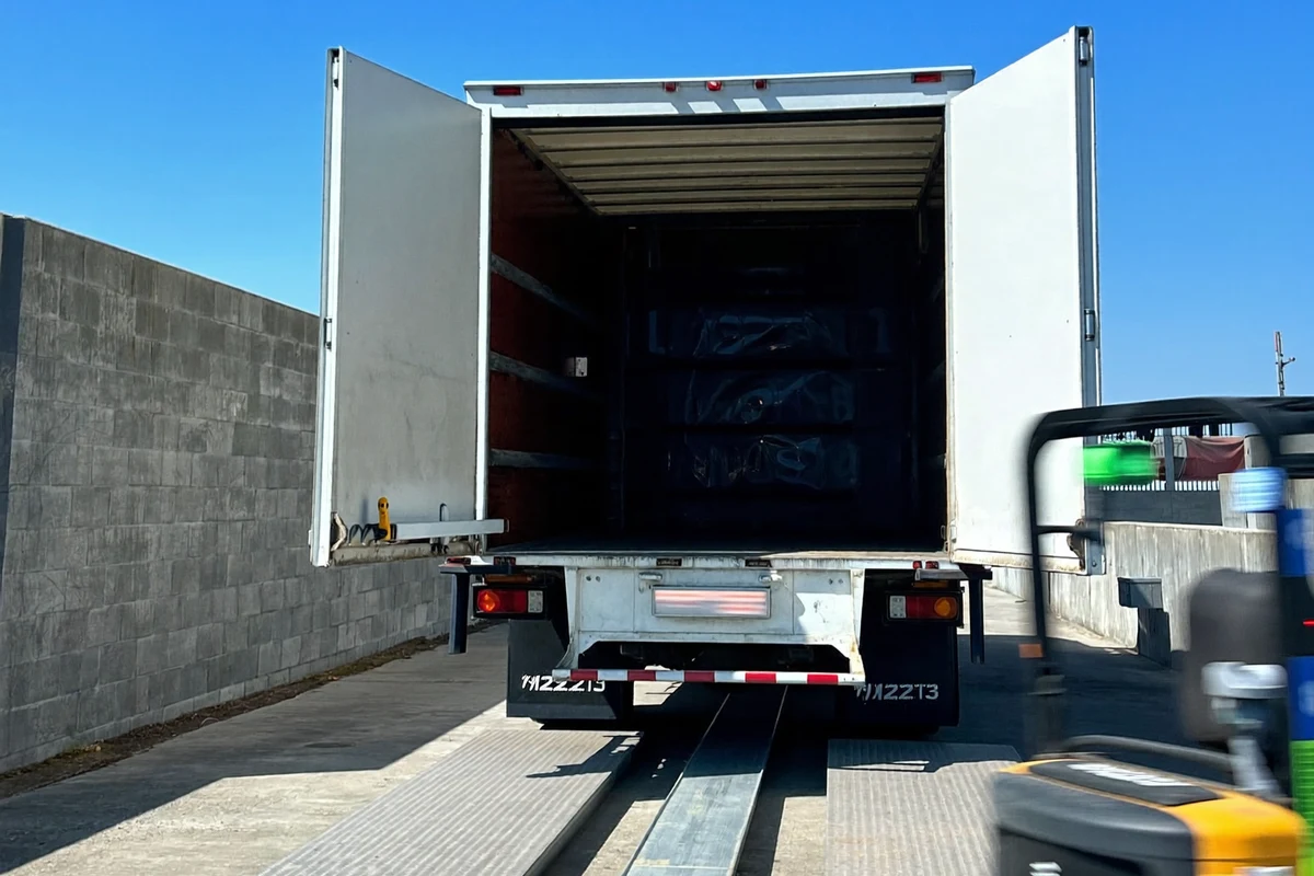 A delivery truck backed up to a loading dock